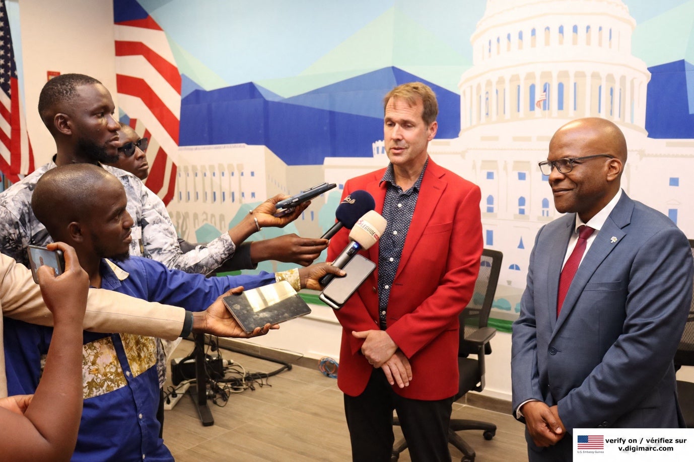 A person in a red suit holding microphones and another person in a red suit holding microphones

AI-generated content may be incorrect.